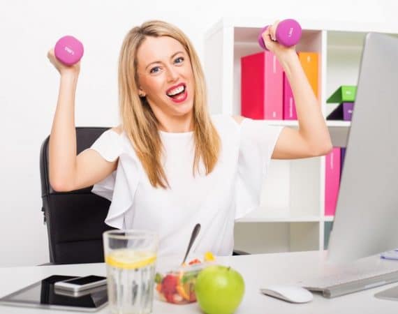 Happy woman in office being active